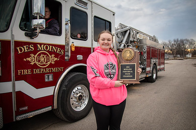 Scarlets Welcome Their Newest State Champion: Truck Number 3 from the Des Moines Fire Department rolled up to East High School on Wednesday morning with the lights flashing and siren blaring. But it was no emergency. Instead they were giving Rileigh Schillinger a special ride to school. The 2024 State High School Bowling Champion hopped down from the fire engine to be greeted by members of the Scarlets marching band and welcomed by family, friends and teachers as she delivered a new addition for the school’s trophy case.